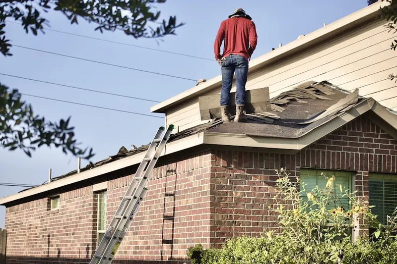 Professional roofer working on a residential roof in Houstonville